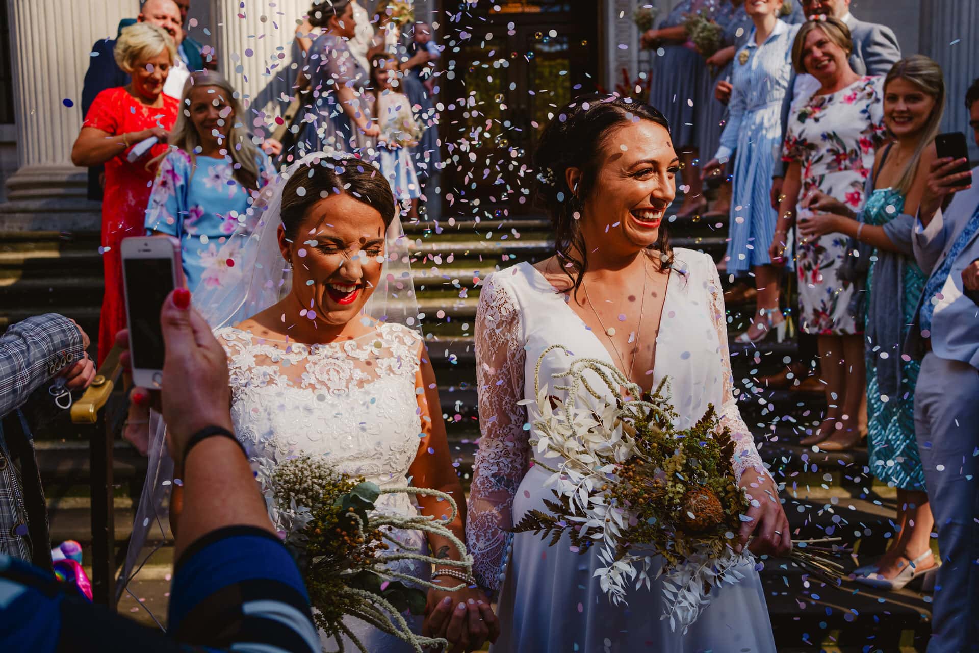happy brides in confetti