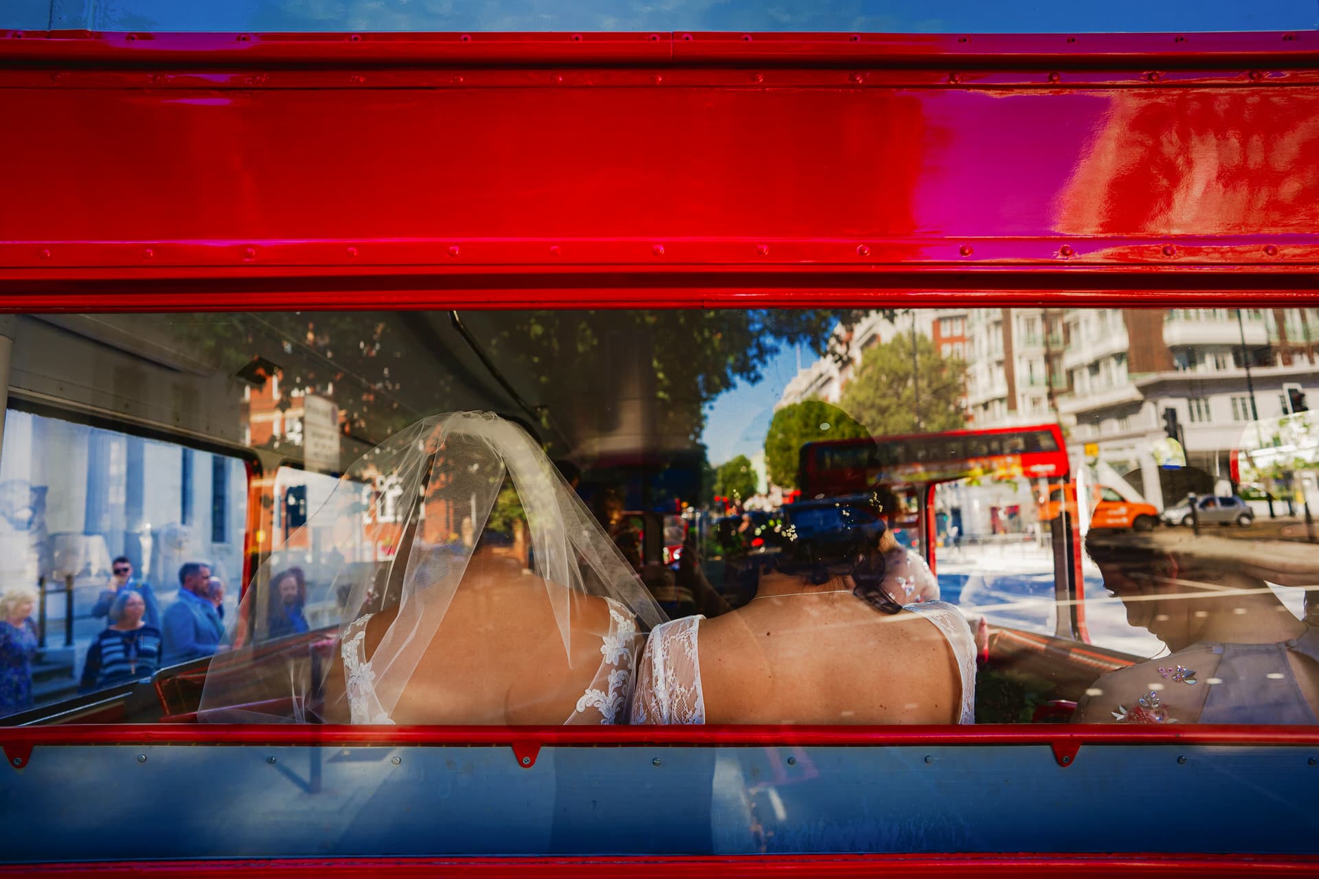 two brides on the backseat of the bus